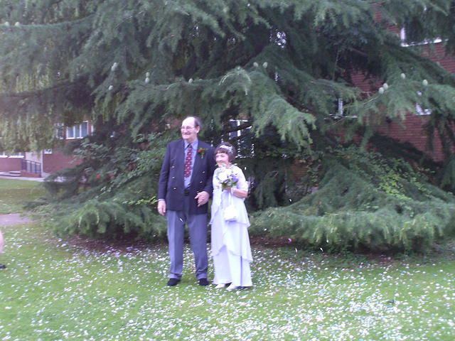 The bride and groom in the grounds of the register office.